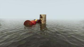 old rusty barrels oil in sea water illustrates the pollution of environment photo