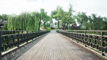 old metal bridge over a small river in park photo