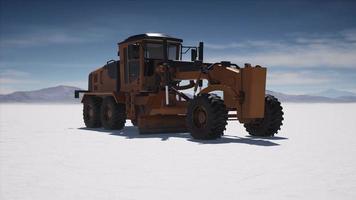 road grading machine on the salt desert road photo