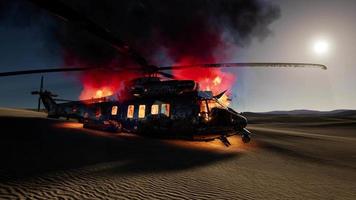 burned military helicopter in the desert at sunset video