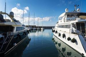 Marina with yachts reflected on the water photo