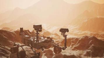 Curiosity Mars Rover exploring the surface of red planet. Elements of this image furnished by NASA video