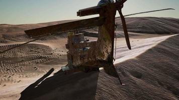 old rusted military helicopter in the desert at sunset video