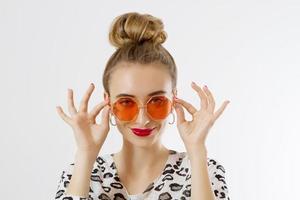 Close-up woman face. Fashion female closeup in trendy clothes isolated on white background. Summer fun time and summertime accessories. Funny girl. photo