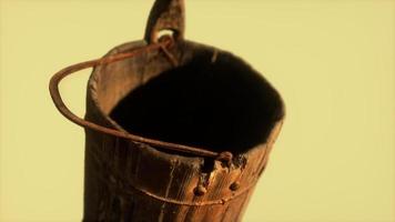 Old used rusted wooden bucket photo