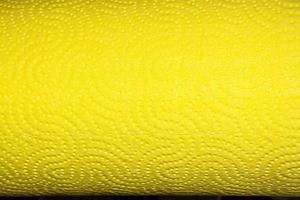 Abstract background texture of perforated paper in yellow color. Copy space. photo