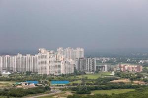 Arial view Cityscape in Gurgaon, Noida, Jaipur, Delhi NCR, Lucknow, Mumbai, Bangalore, Hyderabad showing small houses sky scrapers other commercial real estate infrastructure
