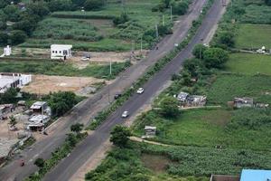 aerial view of a road in between the fields. photo