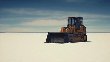 road grading machine on the salt desert road photo