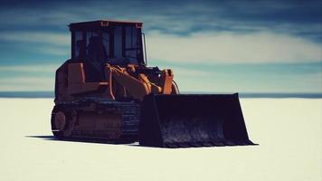 road grading machine on the salt desert road photo