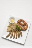 sausage with sauerkraut and pretzel traditional german food meal photo