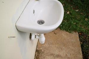 white ceramic sink attached to the wall photo