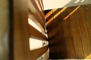 sunlight that emerges from between the wooden chairs photo