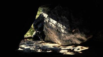 shot taken from inside a small cave looking out photo