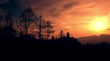 lapso de tempo do pôr do sol com nuvens em camadas movendo-se nas colinas video