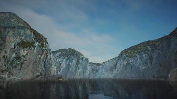 rocky cliffs in the ocean at sunny day video