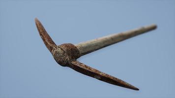 Close up of an old rusted pickaxe head photo