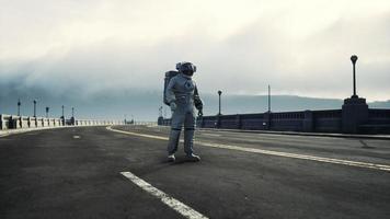 astronaut in space suit on the road bridge photo