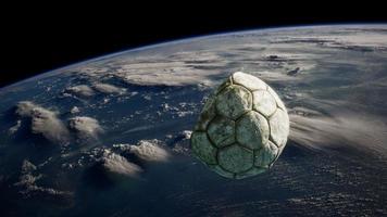 old soccer ball in space on Earth orbit photo
