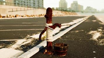 old rusty water pump at sunny day photo