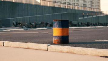 old and rusty metal barrel on parking photo