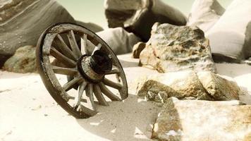 old tradition waggon wheel on the sand photo