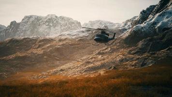 slow motion Vietnam War era helicopter in mountains video