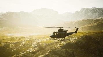 slow motion Vietnam War era helicopter in mountains video