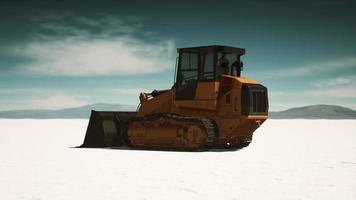 road grading machine on the salt desert road photo