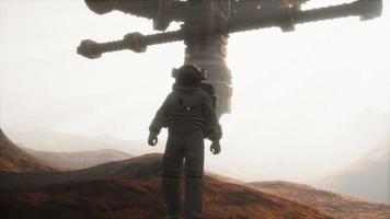 Spaceman walks on the red planet Mars. Space Mission video