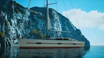 yacht in the sea with greeny rocky island video