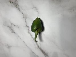 Green chili pepper or Hatch Double-X Hot chile. Numex or New Mexican pod type. Top view photo