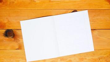 School teacher lays out a alphabet for learning spelling, notebook in an oblique line and the colored pens on a wooden table in the preschool classroom. Copy space for text. Blank sheet page. Top view video