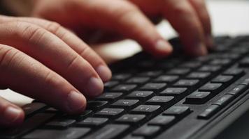 Close up man hands typing on computer keyboard. video