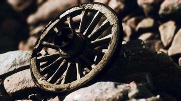 old wooden wheel on rocks video
