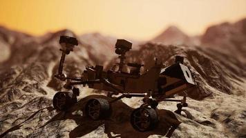 Curiosity Mars Rover exploring the surface of red planet. Elements of this image furnished by NASA video