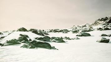 lava rock and snow in winter time in Iceland photo
