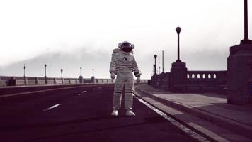 astronaut walks in the middle of a road photo