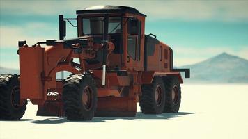 road grading machine on the salt desert road photo