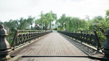 old bridge in park in summer time photo