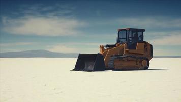 road grading machine on the salt desert road photo