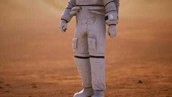 Astronaut on Mars Surface. Red Planet Covered in Gas and rock photo