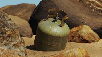 antiguo cilindro de gas de cocina en la playa de arena foto