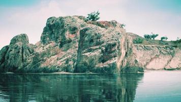 beautiful rocky cliff in the middle of the sea photo