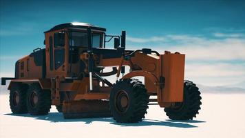 road grading machine on the salt desert road photo