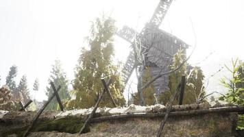 old traditional wooden windmill in the forest photo