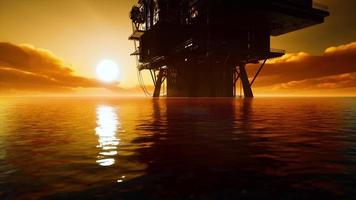 old oil platform during sunset in ocean photo