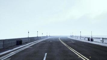 illuminated empty road bridge in a fog photo