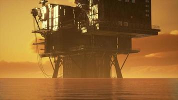 old oil platform during sunset in ocean photo