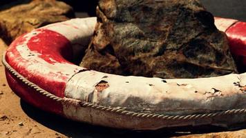 old life buoy on sandy beach photo